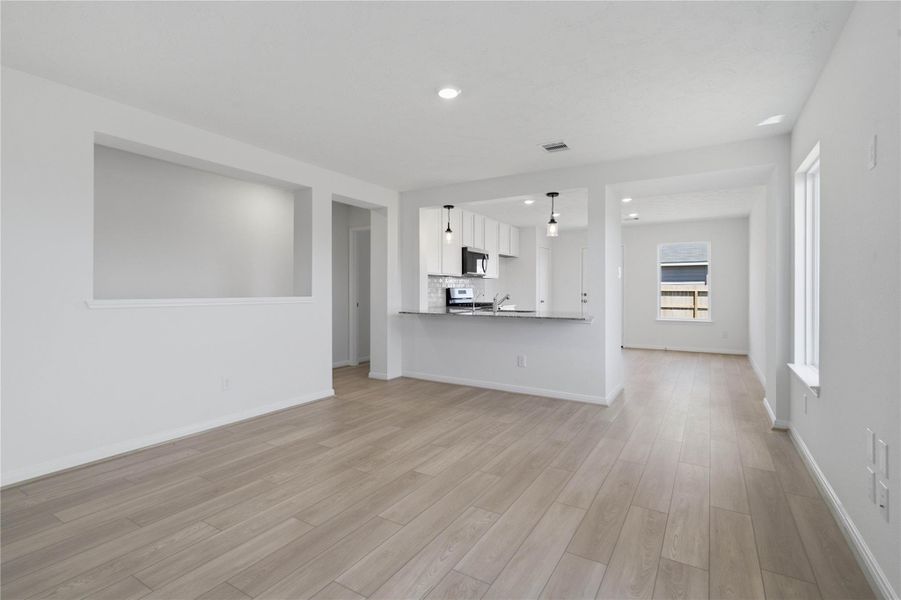 Stunning open-concept design seamlessly connecting the living, dining, and kitchen areas—perfect for both everyday living and entertaining!