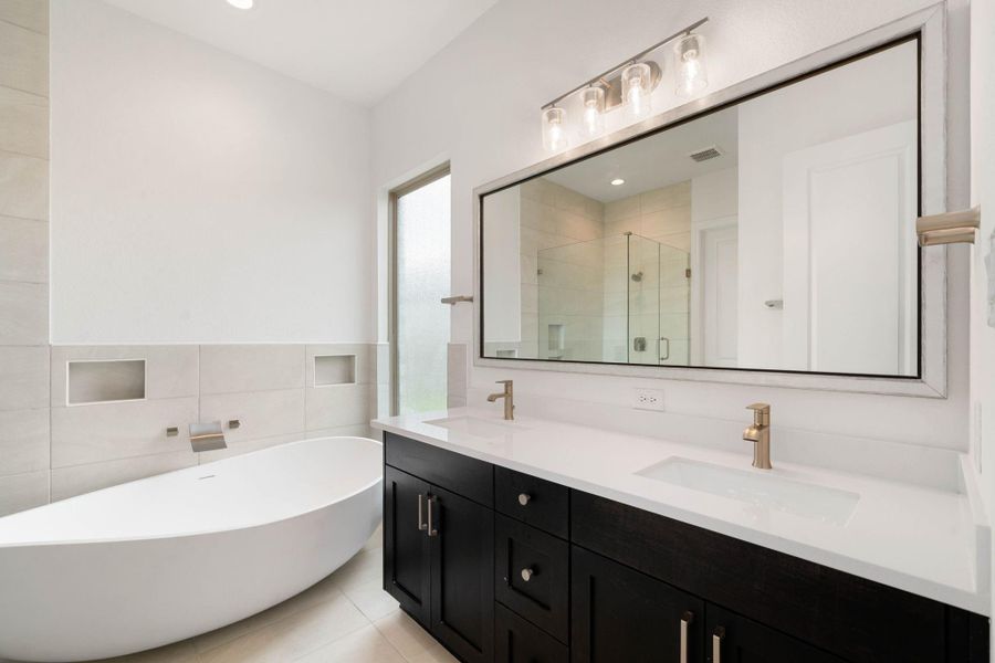 Now this is a bathroom suite that you can relax in! Double sinks, LED lighting, and a massive tub and shower make getting ready or relaxing enjoyable.