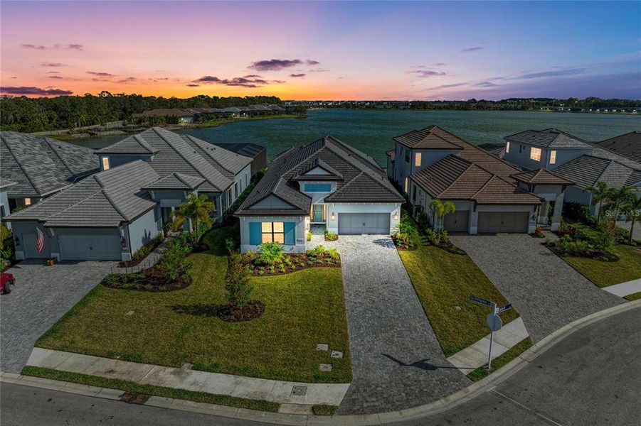 Front exterior of a new home in The Alcove at Waterside, Sarasota, FL, highlighting curb appeal (Image 26). Front exterior of a new home in The Alcove at Waterside, Sarasota, FL, highlighting curb appeal (Image 26).