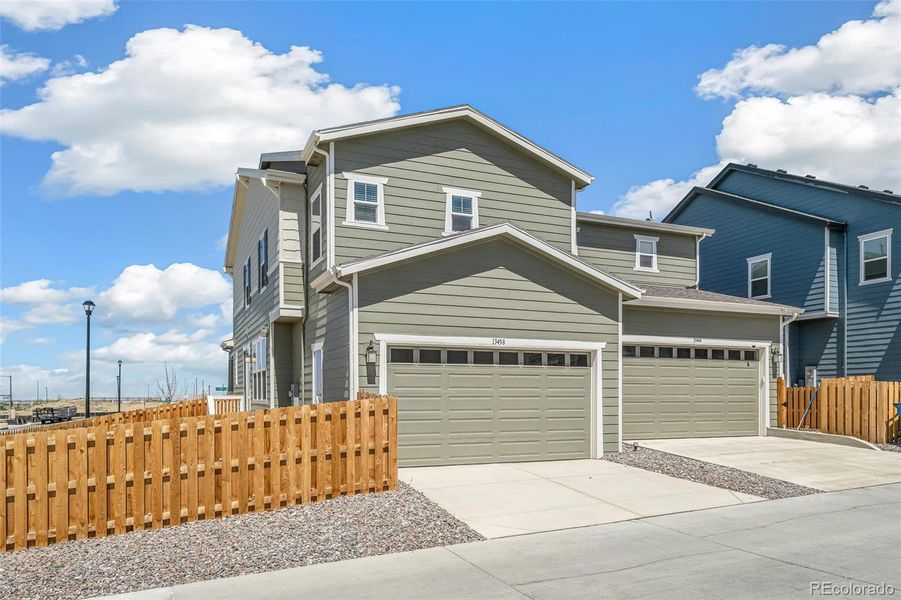 Front exterior of a new home in Turnberry, Commerce City, CO, highlighting curb appeal (Image 23). Front exterior of a new home in Turnberry, Commerce City, CO, highlighting curb appeal (Image 23).