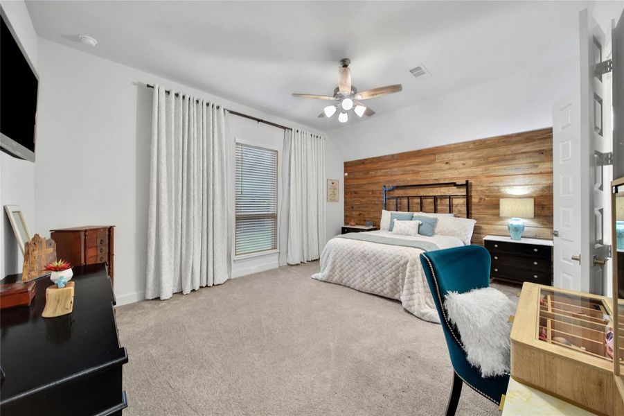 Tucked at the back of the home for added privacy, the spacious primary suite offers a peaceful retreat away from the secondary bedrooms and main living areas.