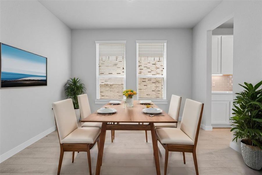 You and your guests will certainly dine in style in this amazing formal dining room! Featuring large windows with blinds, neutral paint, high ceilings, and tile flooring! Perfect space to entertain family and friends!