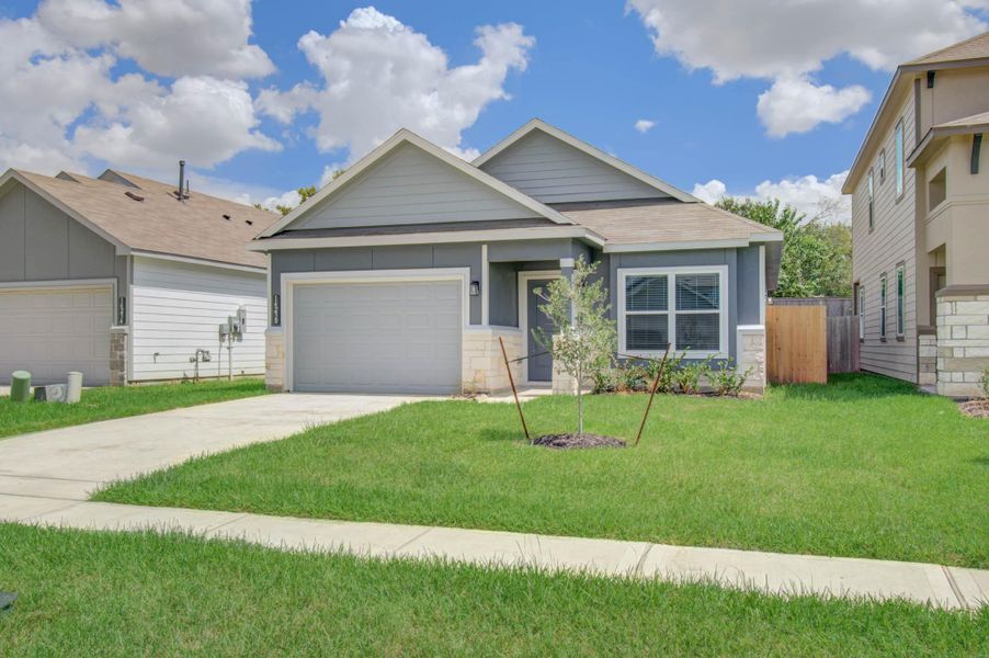 Charming single-story home featuring a modern exterior with a welcoming front porch, lush green lawn, and attached garage.