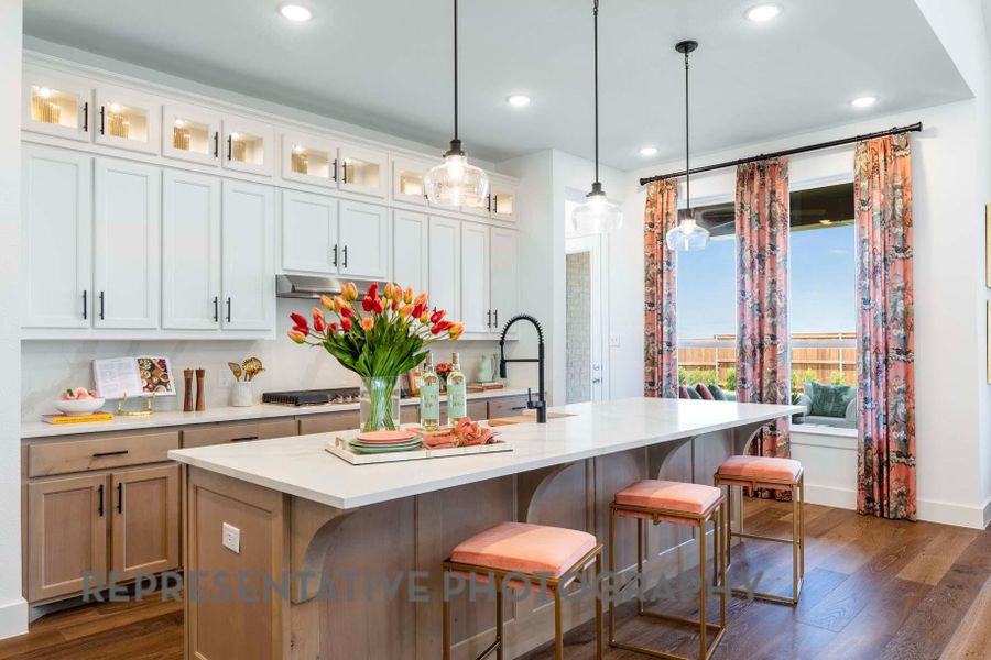 Kitchen featuring light countertops, a breakfast bar area, and dark wood finished floors Kitchen featuring light countertops, a breakfast bar area, and dark wood finished floors