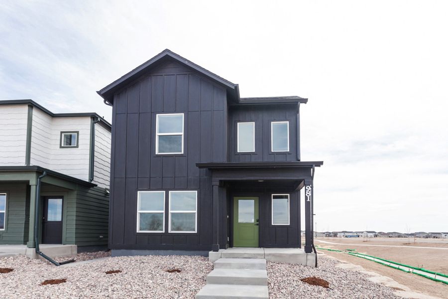 Front exterior of a new home in Prairie Song, Windsor, CO, highlighting curb appeal (Image 2). Front exterior of a new home in Prairie Song, Windsor, CO, highlighting curb appeal (Image 2).