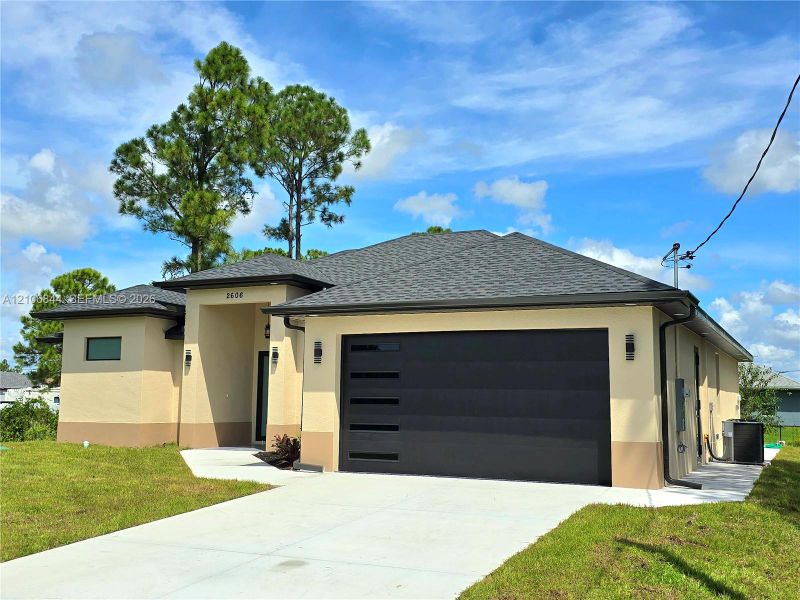 Front exterior of a new home in , Lehigh Acres, FL, highlighting curb appeal (Image 18). Front exterior of a new home in , Lehigh Acres, FL, highlighting curb appeal (Image 18).