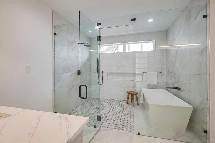 Bathroom featuring tile walls, tile flooring, and independent shower and bath