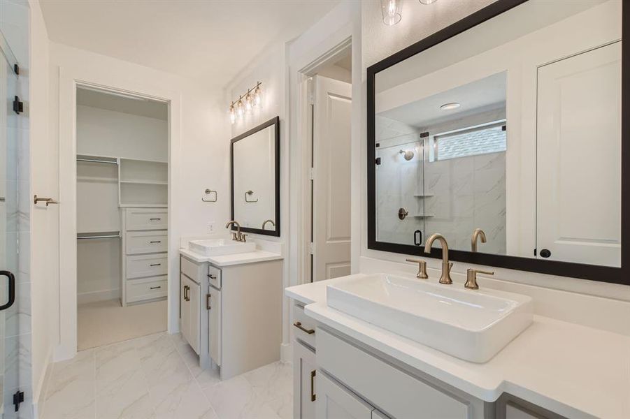 Bathroom featuring a shower with door and vanity