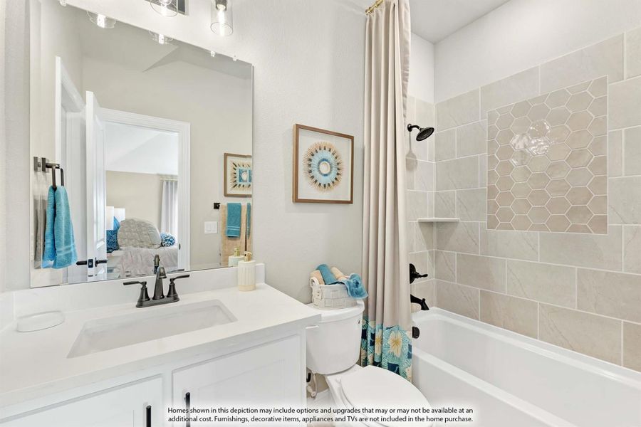 Bathroom with white vanity, large mirror, and tiled shower-tub combo with curtain Bathroom with white vanity, large mirror, and tiled shower-tub combo with curtain