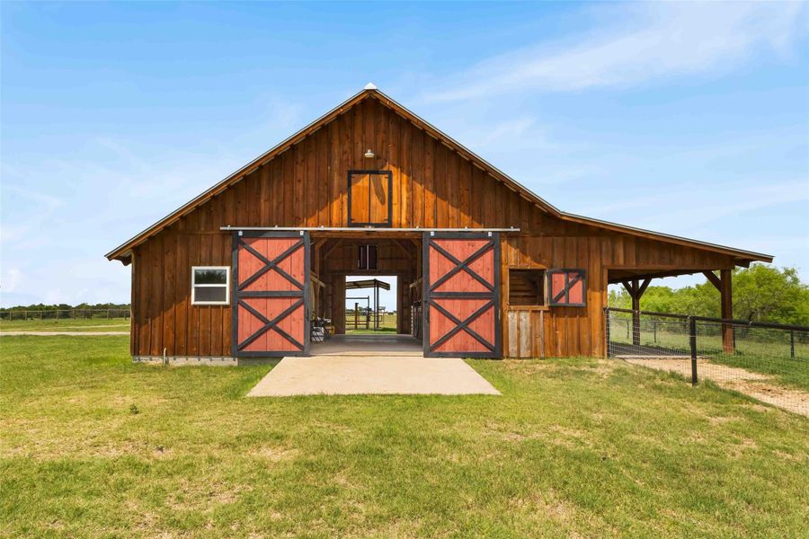 View of barn featuring an exterior structure View of barn featuring an exterior structure