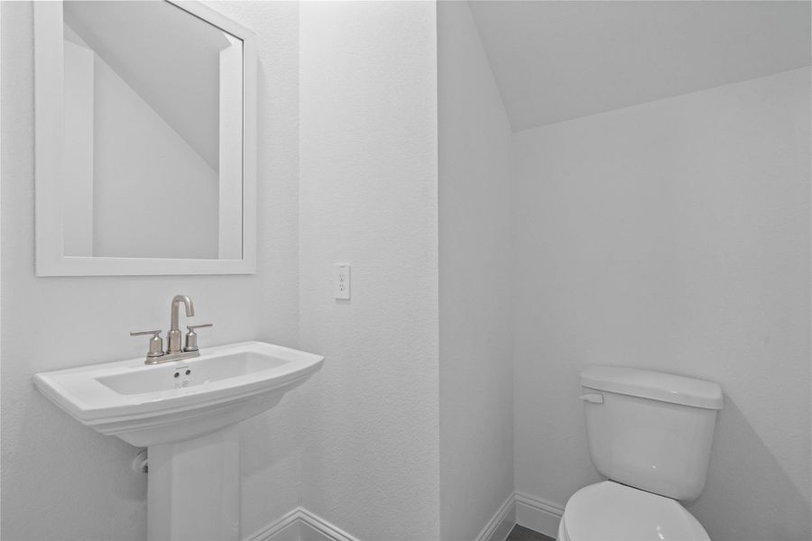 The powder bath features a stylish vanity and a clean, modern design. The powder bath features a stylish vanity and a clean, modern design.