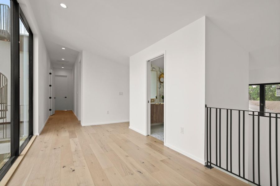 Empty room featuring light wood finished floors and recessed lighting