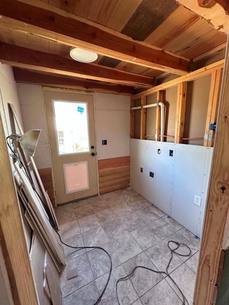 A skylight brightens this utility space, offering potential for various functional designs.