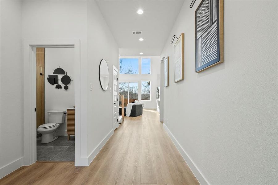 Hallway featuring light wood finished floors and recessed lighting
