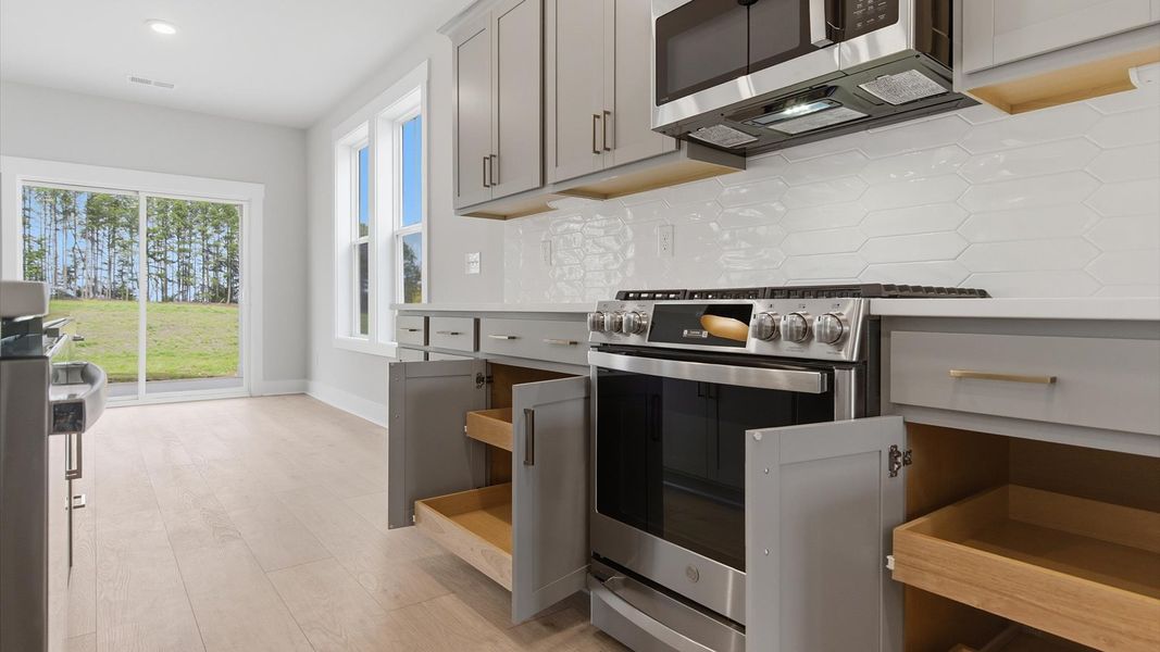 Superior kitchen with quartz countertops, abundant storage, and stainless steel appliances in Gray Court, SC