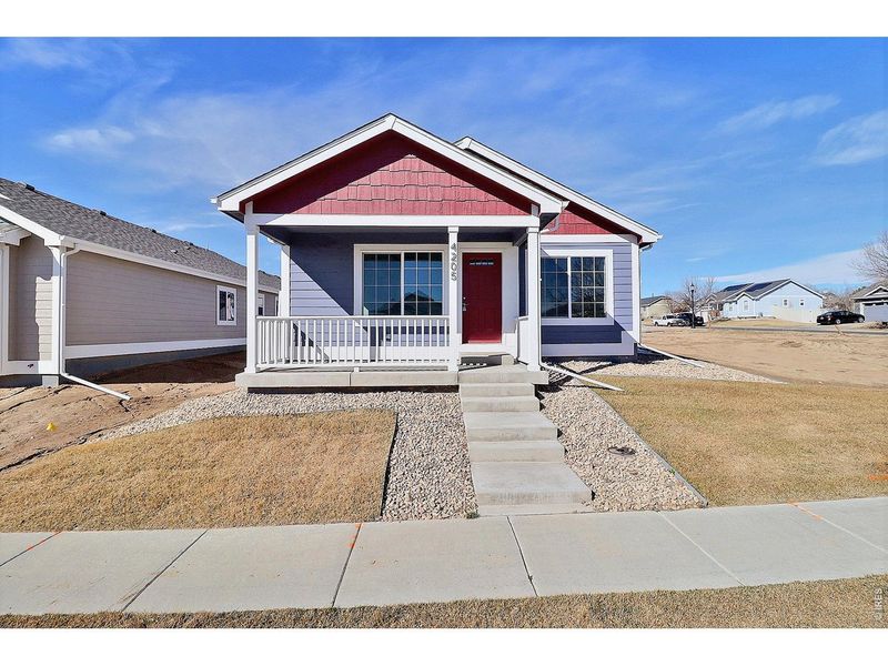 Front exterior of a new home in , Evans, CO, highlighting curb appeal (Image 19).