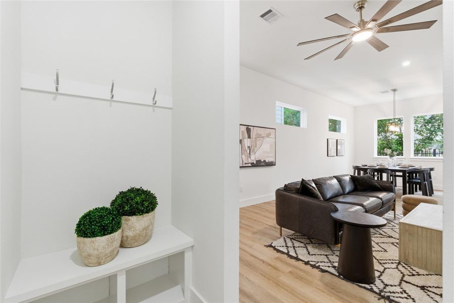 A functional entry nook adds convenience, opening into the bright, open living space that flows effortlessly throughout the home.