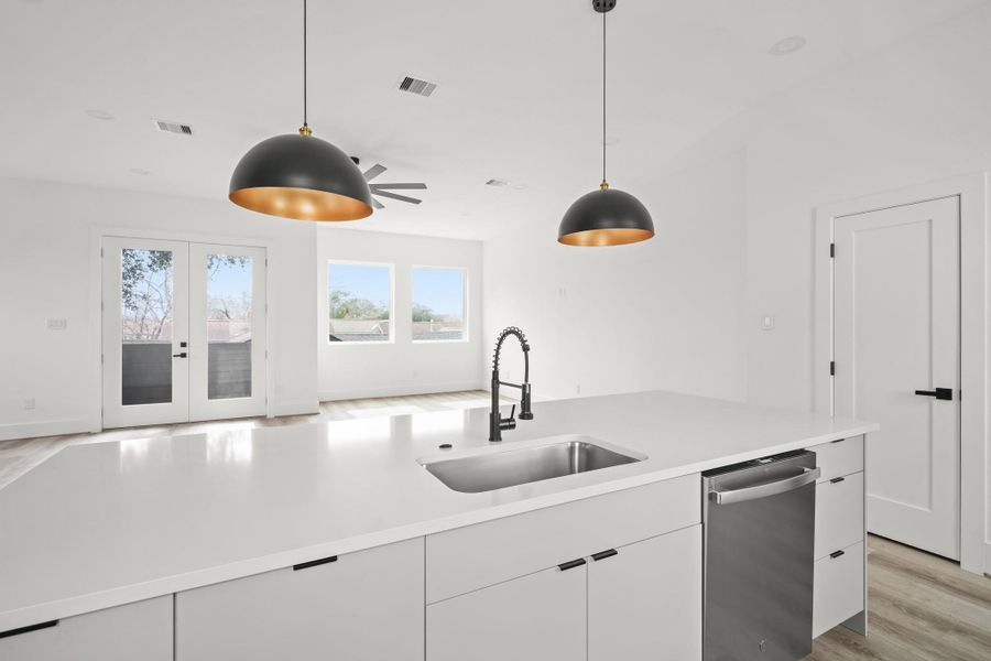 The chef inspired kitchen features premium inset style cabinetry, a large quartz island with breakfast bar seating that opens beautifully to the main living area. The chef inspired kitchen features premium inset style cabinetry, a large quartz island with breakfast bar seating that opens beautifully to the main living area.