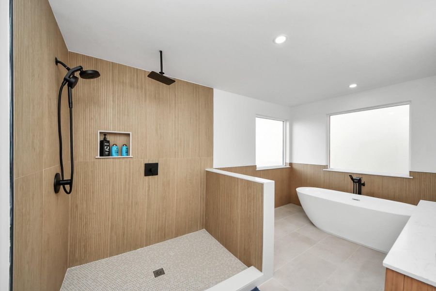Modern open concept with a spacious walk-in shower, sleek black fixtures, and a freestanding tub. The neutral tones and ample natural light create a serene spa-like atmosphere. Modern open concept with a spacious walk-in shower, sleek black fixtures, and a freestanding tub. The neutral tones and ample natural light create a serene spa-like atmosphere.