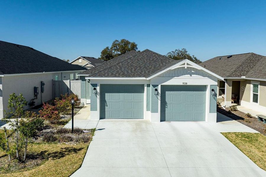 Front exterior of a new home in , The Villages, FL, highlighting curb appeal (Image 22).