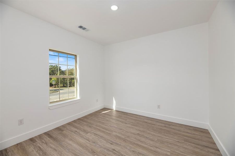Spare room with wood finished floors and recessed lighting Spare room with wood finished floors and recessed lighting