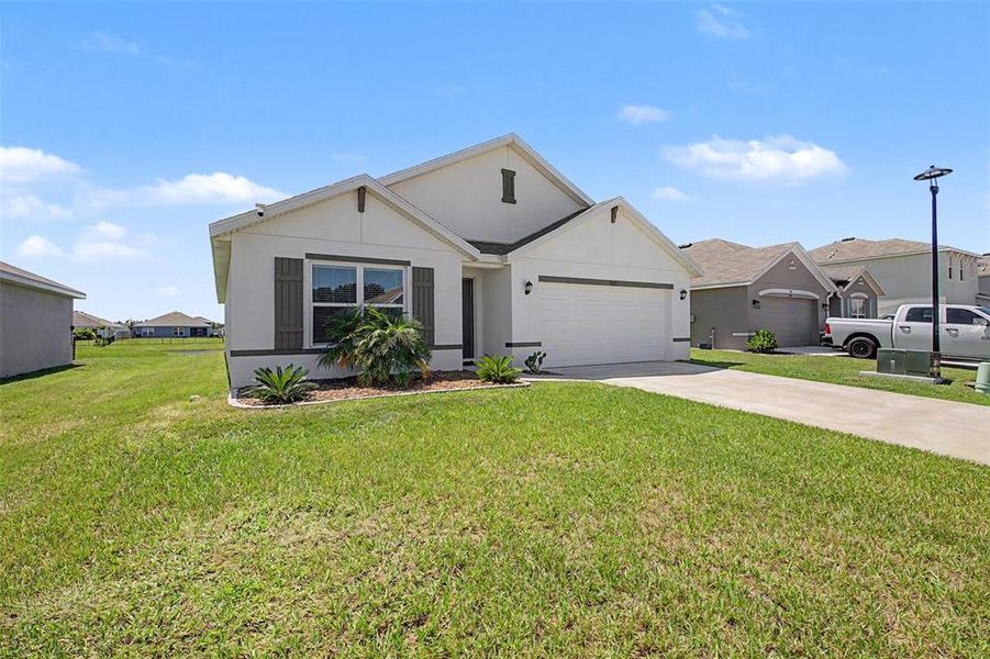 Front exterior of a new home in Mandarin Grove, Palmetto, FL, highlighting curb appeal (Image 24).