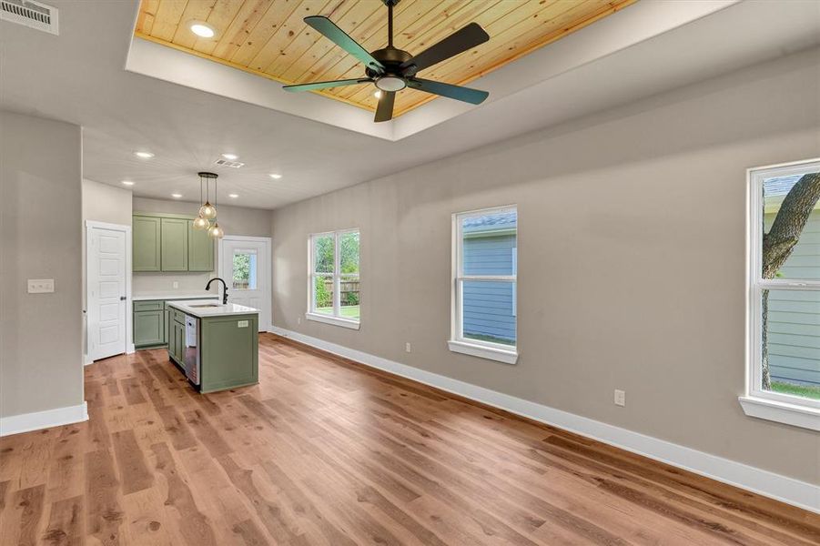 Kitchen featuring green cabinetry, recessed lighting, a tray ceiling, wooden ceiling, and light wood finished floors Kitchen featuring green cabinetry, recessed lighting, a tray ceiling, wooden ceiling, and light wood finished floors