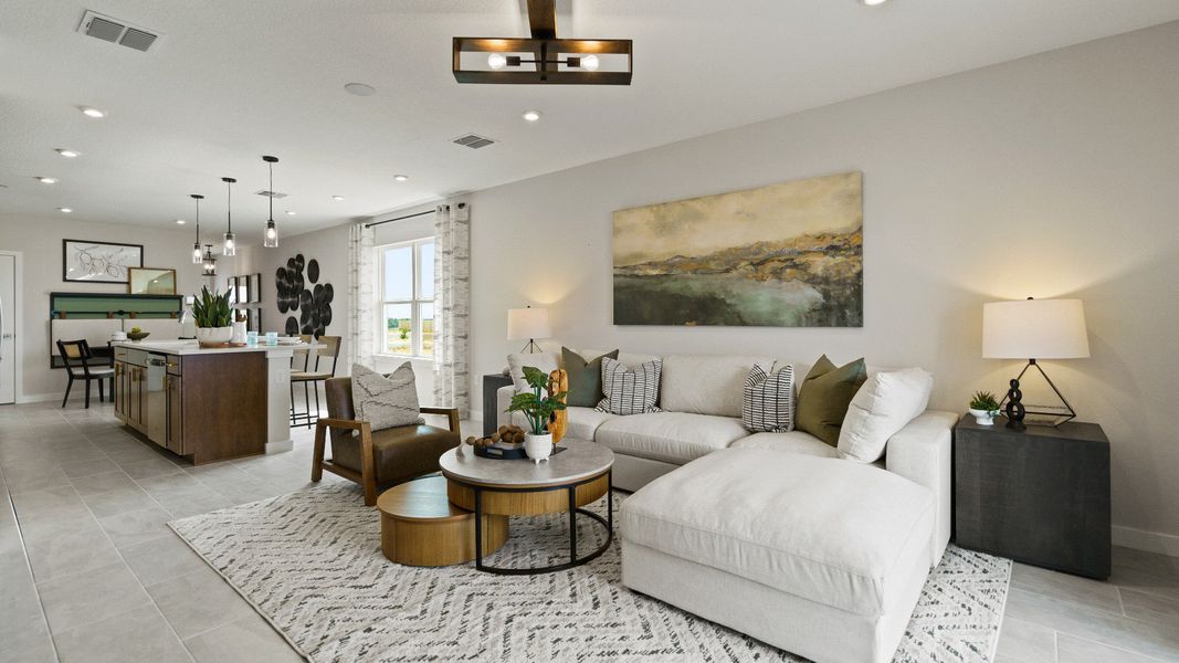 Spacious great room in The Atlantic plan with designer finishes, natural light, and modern open kitchen layout.