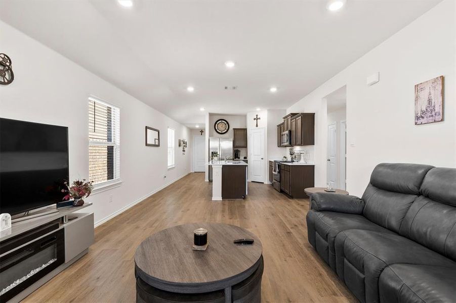 Living room with light wood finished floors and recessed lighting Living room with light wood finished floors and recessed lighting