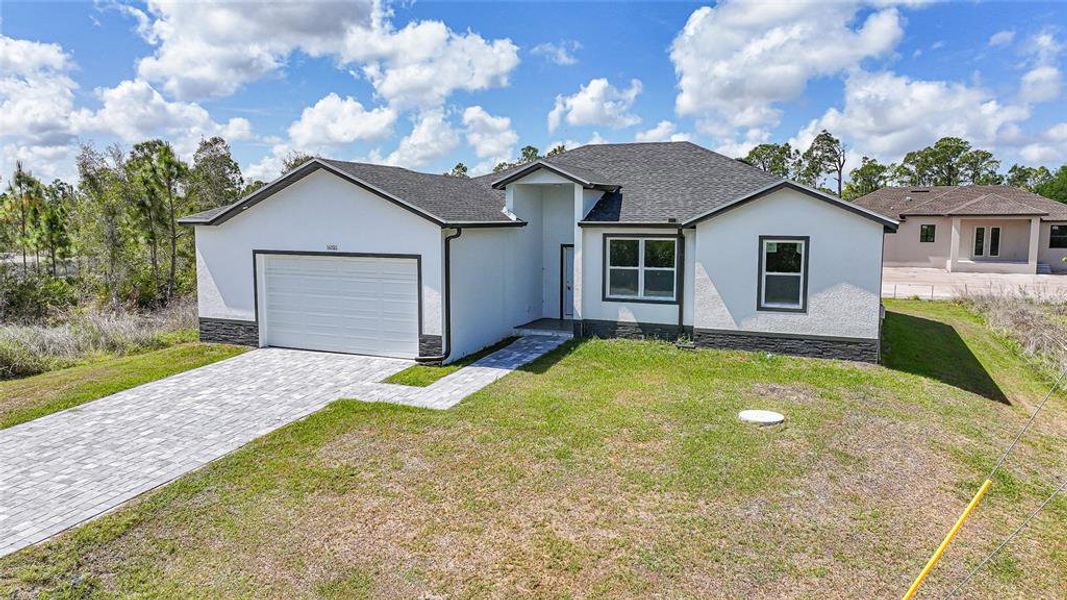 Front exterior of a new home in , Port Charlotte, FL, highlighting curb appeal (Image 25).