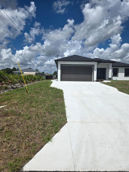 Front exterior of a new home in , Lehigh Acres, FL, highlighting curb appeal (Image 17). Front exterior of a new home in , Lehigh Acres, FL, highlighting curb appeal (Image 17).