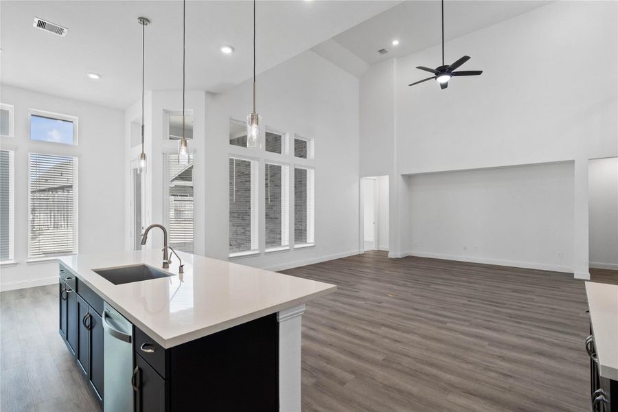 Enjoy commanding sightlines across the oversized kitchen island into the family room and this open-concept layout. Enjoy commanding sightlines across the oversized kitchen island into the family room and this open-concept layout.
