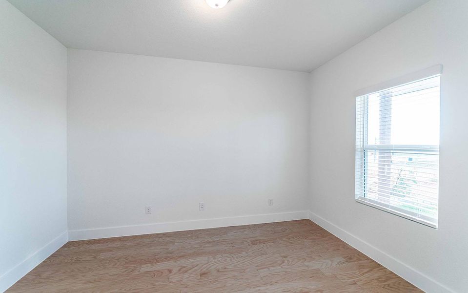 Spare room featuring light wood-style floors and baseboards Spare room featuring light wood-style floors and baseboards