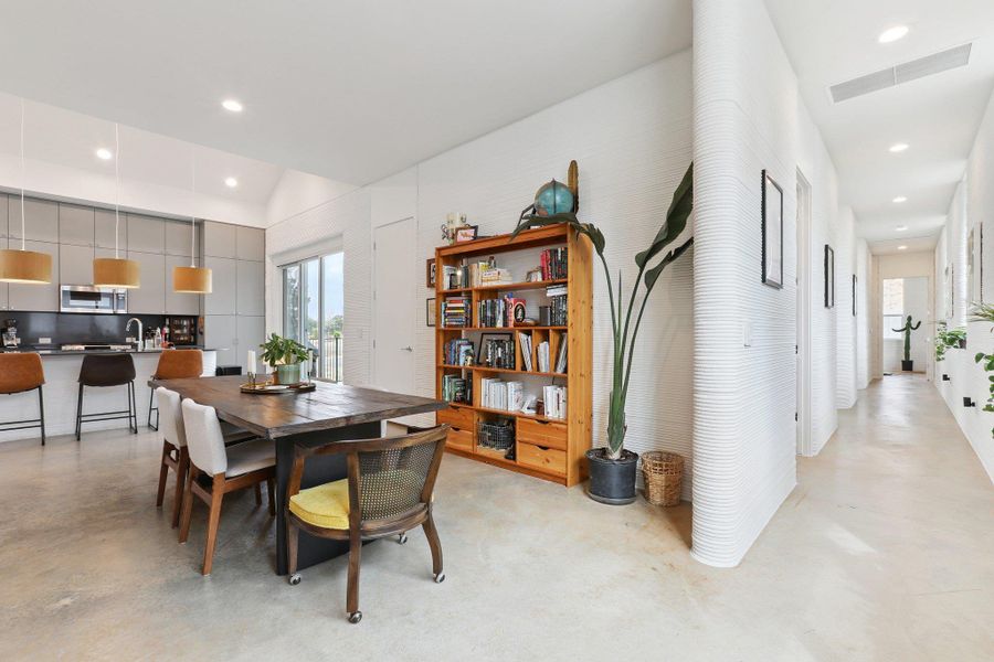 Dining space featuring finished concrete floors and recessed lighting