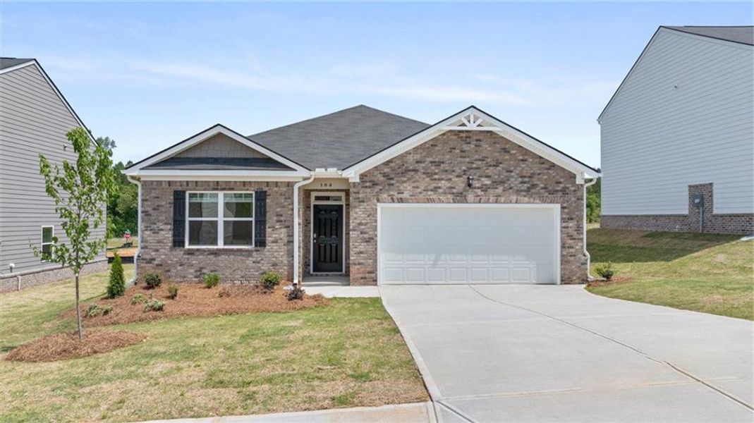 Front exterior of a new home in The Reserve at Calcutta, Stockbridge, GA, highlighting curb appeal (Image 1). Front exterior of a new home in The Reserve at Calcutta, Stockbridge, GA, highlighting curb appeal (Image 1).