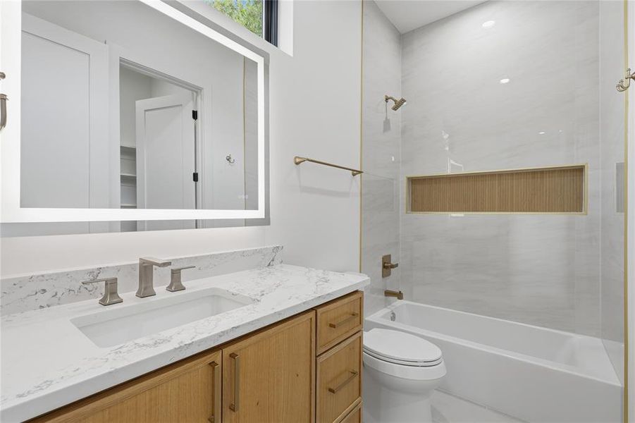 Modern bathroom featuring a wood-finish vanity with an integrated rectangular sink and a quartz countertop Modern bathroom featuring a wood-finish vanity with an integrated rectangular sink and a quartz countertop