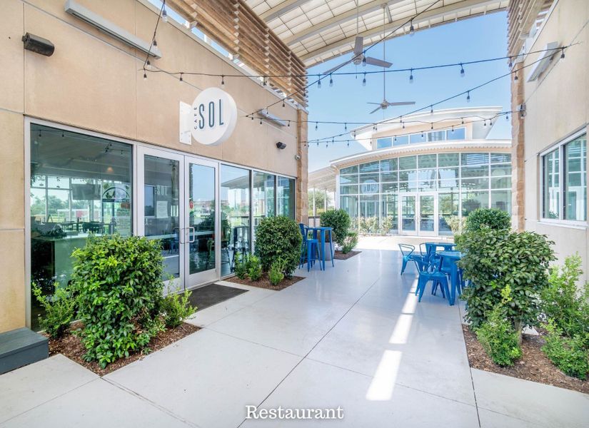 Charming outdoor dining area with modern seating and lush greenery, perfect for enjoying meals in a vibrant atmosphere. Charming outdoor dining area with modern seating and lush greenery, perfect for enjoying meals in a vibrant atmosphere.
