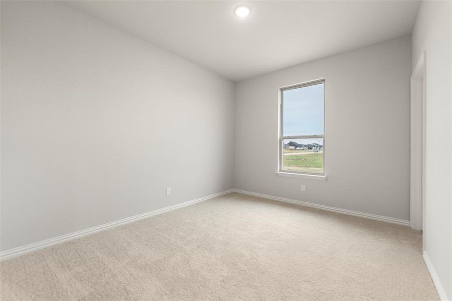 Unfurnished room featuring light colored carpet and recessed lighting Unfurnished room featuring light colored carpet and recessed lighting