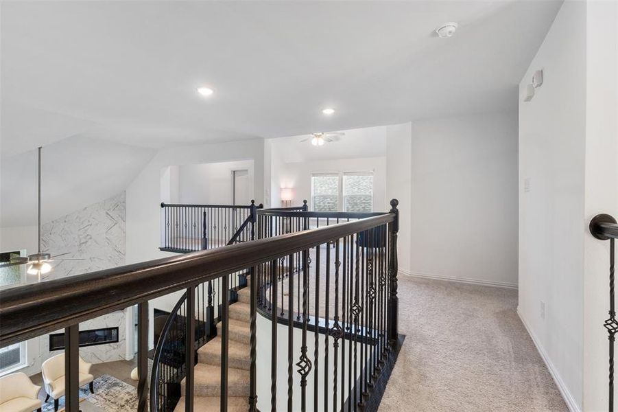 Hall featuring light colored carpet, an upstairs landing, recessed lighting, and lofted ceiling