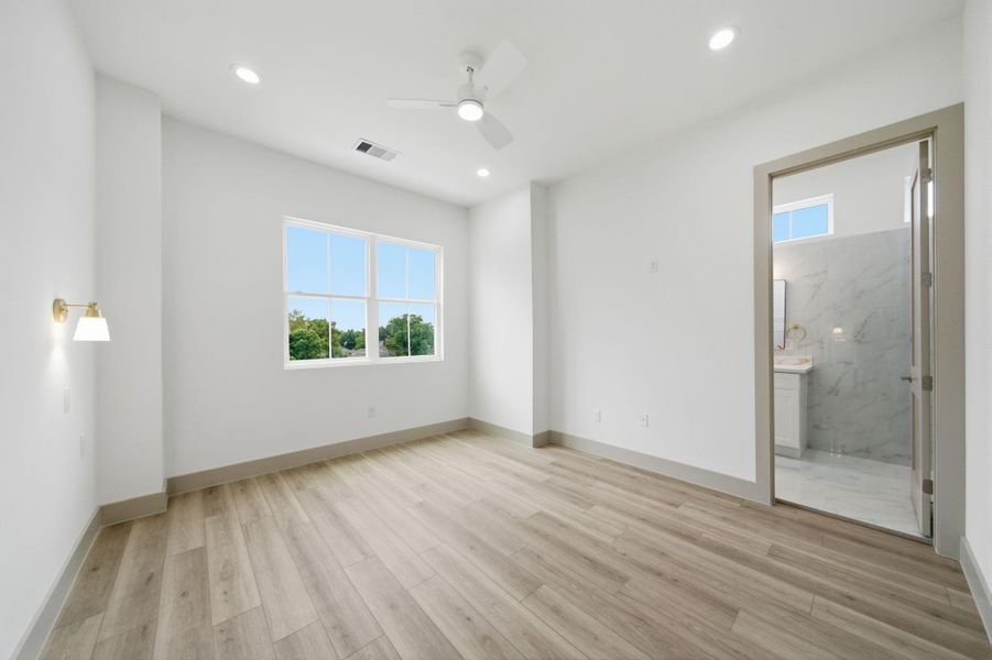 Primary bedroom with tall 11' ceilings (and 11' throughout the home!). NO CARPET in this home!