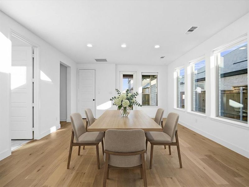 Dining area featuring recessed lighting and light wood-style floors Dining area featuring recessed lighting and light wood-style floors