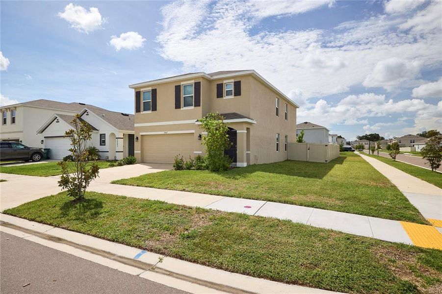 Front exterior of a new home in Westgate at Avalon Park, Wesley Chapel, FL, highlighting curb appeal (Image 26).
