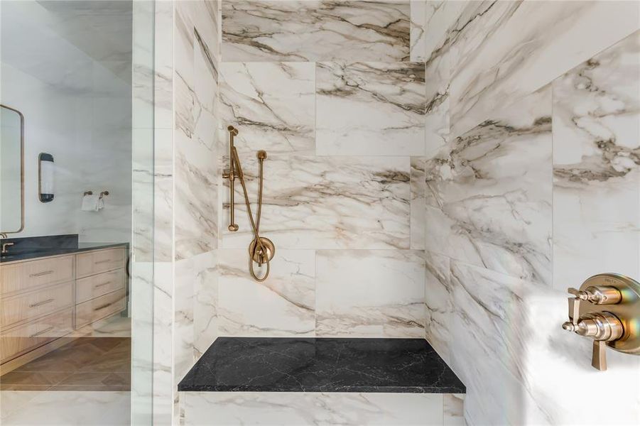 Bathroom featuring vanity and tiled shower