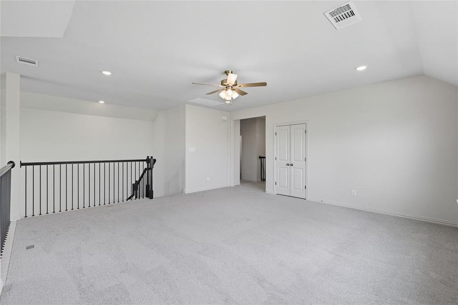 Empty room with carpet, recessed lighting, and vaulted ceiling Empty room with carpet, recessed lighting, and vaulted ceiling