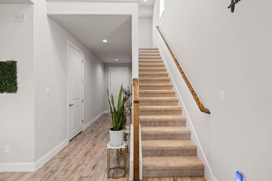 Stairs with baseboards, visible vents, wood finished floors, and recessed lighting Stairs with baseboards, visible vents, wood finished floors, and recessed lighting