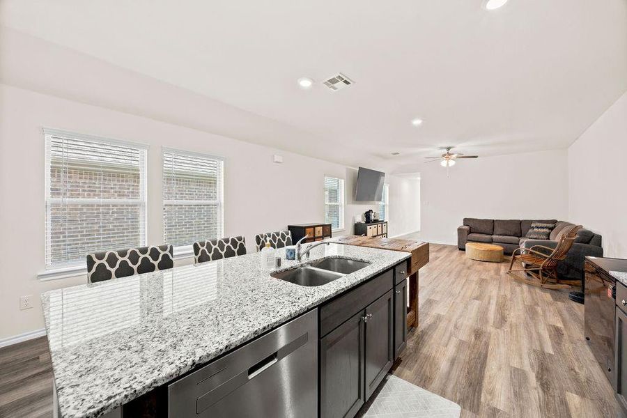 Kitchen island with granite countertops, stainless steel undermount sink, and integrated dishwasher Kitchen island with granite countertops, stainless steel undermount sink, and integrated dishwasher