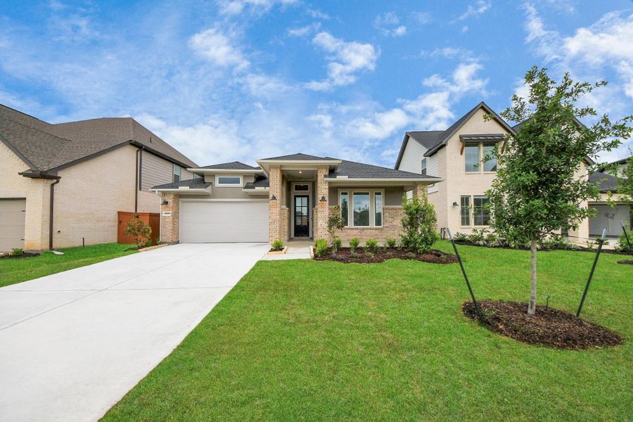 Front exterior of a new home in 50' Traditional Homes at Elyson, Katy, TX, highlighting curb appeal (Image 18). Front exterior of a new home in 50' Traditional Homes at Elyson, Katy, TX, highlighting curb appeal (Image 18).
