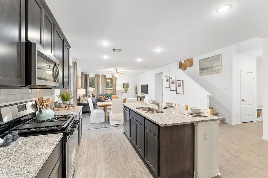 A kitchen with a wood floor.