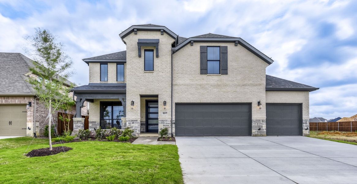 Front exterior of a new home in M3 Ranch, Mansfield, TX, highlighting curb appeal (Image 2).