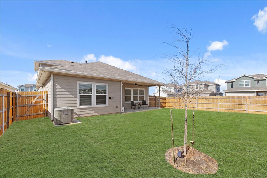 The perfect extension of home. Enjoy seamless indoor-outdoor living with a spacious covered porch that overlooks a meticulously maintained yard, offering plenty of room for people and gatherings.